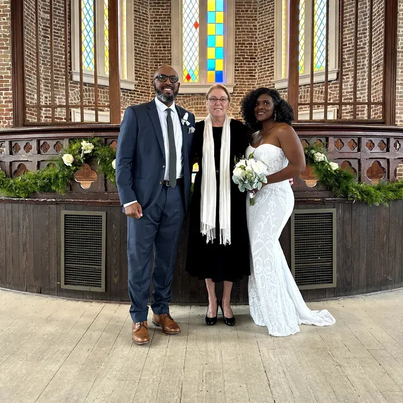 Bride, groom, and officiant in a New Orleans chapel wedding